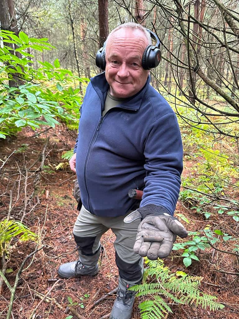 Photograph of a man showing a find from Sherwood Pines