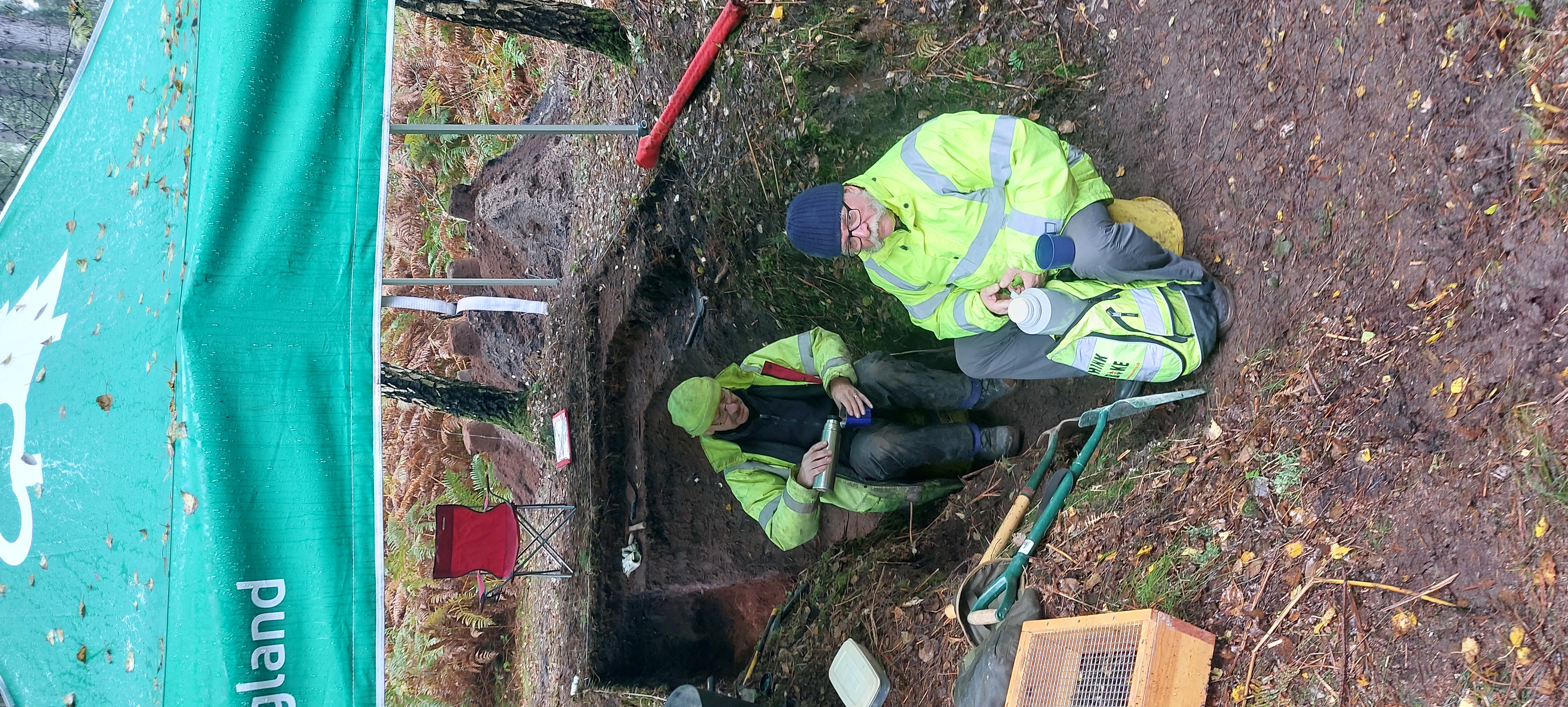 Photograph of a couple of people having a break from excavating Sherwood Pines