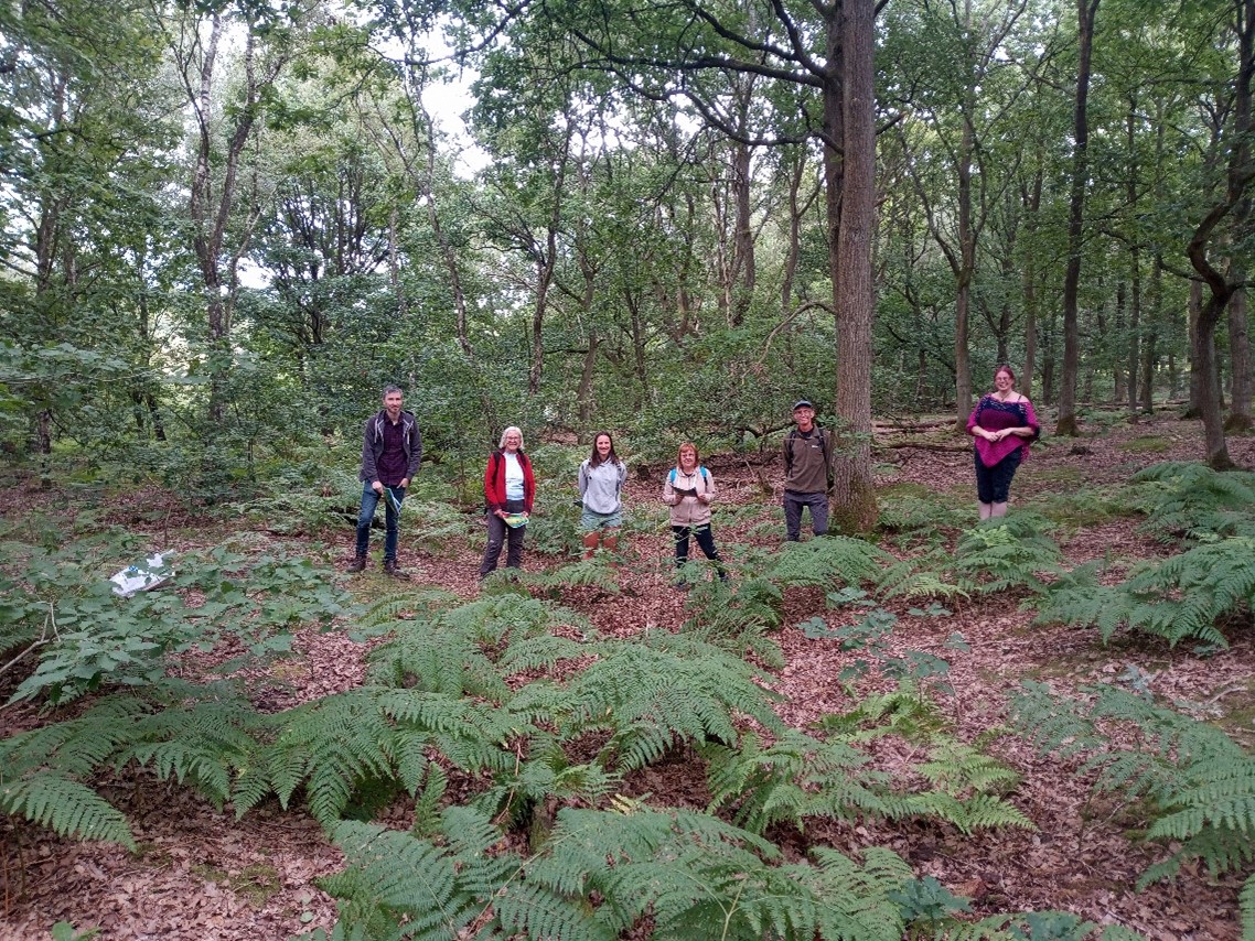 NWT volunteers and Nottinghamshire County Council archaeologist Emily Gillott standing in the contours of the Medieval hollow way